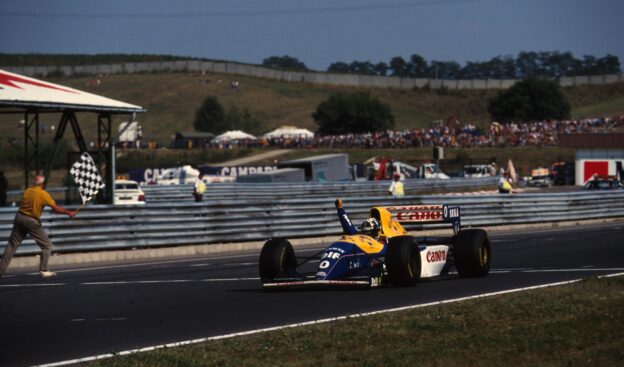 Damon Hill, Williams FW 15C takes the chequered flag for his first Grand Prix victory. Hungarian Grand Prix, Hungaroring, 15 August 1993.