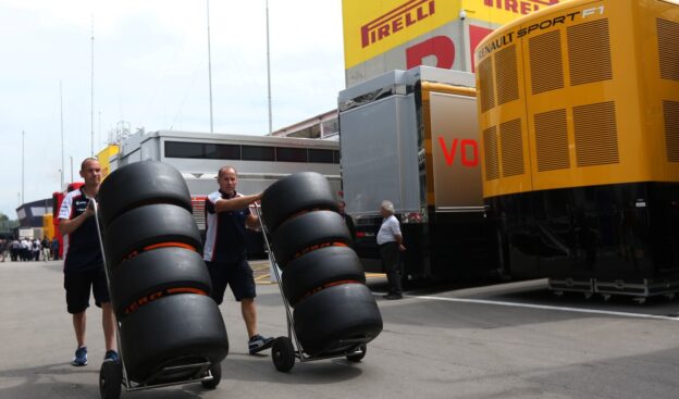 Williams Mechanics wheeling tyres through the paddock