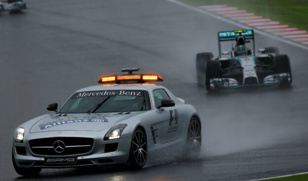 F1 cars driving behind safety car