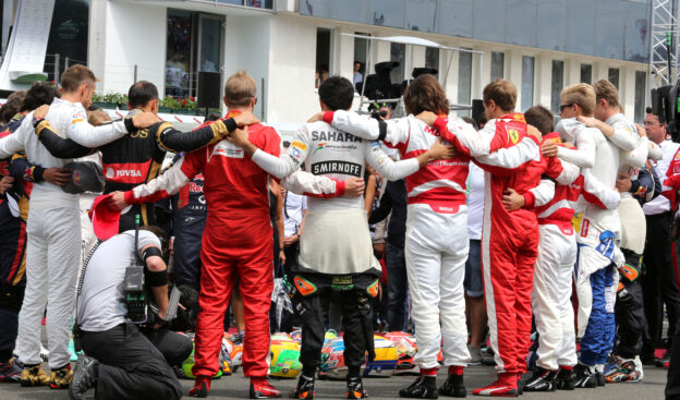 The drivers observe the tribute to Jules Bianchi on the grid.