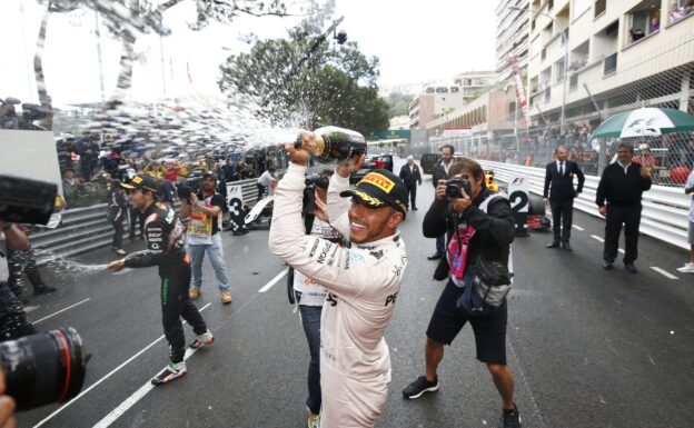 Lewis Hamilton celebrates his Monaco victory with a champagne shower over his team