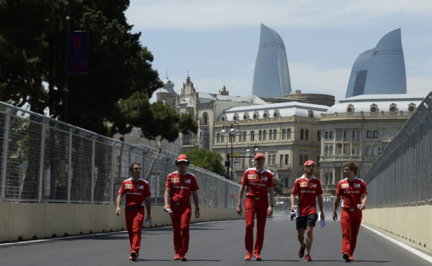 Sebastian Vettel walking with Ferrari crew on the Baku Street Circuit