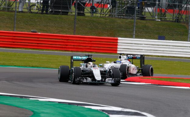 Lewis Hamilton in his Mercedes W07 followed by Felipe Massa in his Williams FW38 on Silverstone