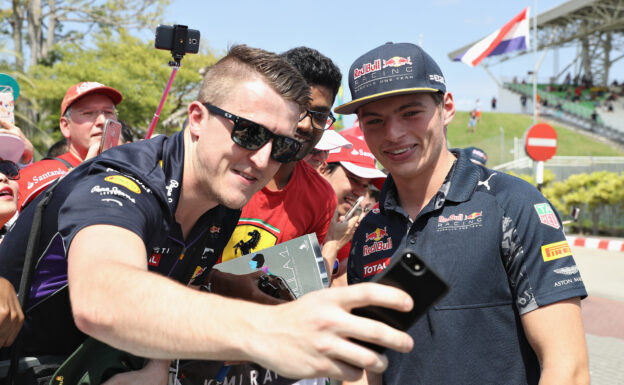 Max Verstappen poses for a photo with a F1 Fan