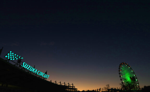 A general view of the Suzuka Circuit sign and the big wheel as the sun goes down.