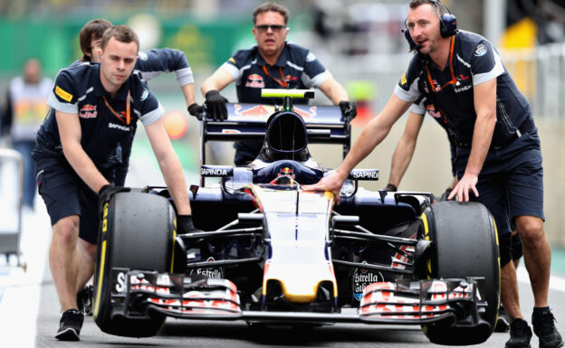 The Scuderia Toro Rosso team push the car of Carlos Sainz down the pit lane during final practice for the Formula One Grand Prix of Brazil 2016