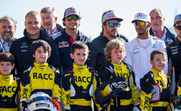 Valterri Bottas of Mercedes and Finland Carlos Sainz of Scuderia Toro Rosso and Spain Fernando Alonso of McLaren and Spain Lewis Hamilton of Mercedes and Great Britain pose with children from the Fernando Alonso of McLaren and Spain Karting School during previews to the Spanish Formula One Grand Prix at Circuit de Catalunya on May 11, 2017 in Montmelo, Spain.