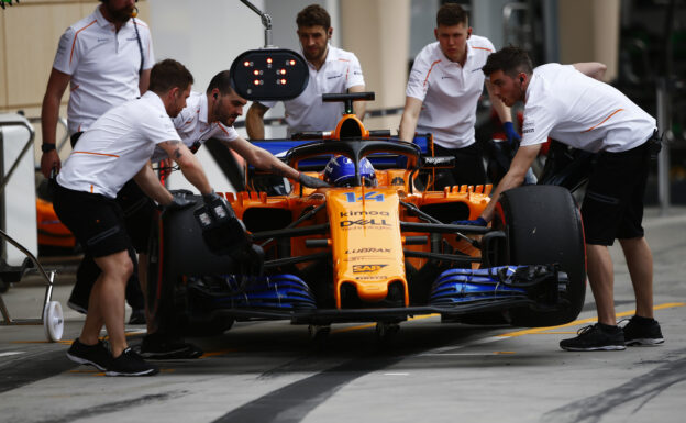 Bahrain International Circuit, Sakhir, Bahrain. Friday 6 April 2018. Mechanics push the Fernando Alonso McLaren MCL33 Renault in the pit lane.