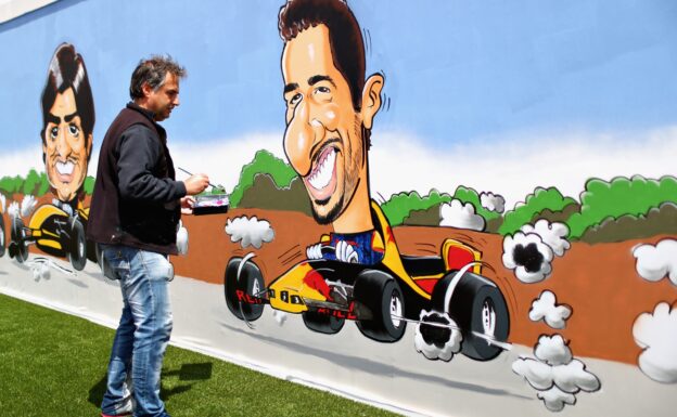 An artist paints a Daniel Ricciardo of Australia and Red Bull Racing mural in the fan area during the Spanish Formula One Grand Prix at Circuit de Catalunya on May 13, 2018 in Montmelo, Spain.