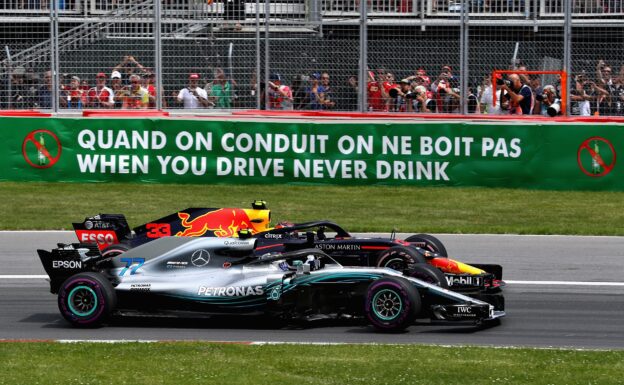 Max Verstappen driving the (33) Aston Martin Red Bull Racing RB14 TAG Heuer and Valtteri Bottas driving the (77) Mercedes AMG Petronas F1 Team Mercedes WO9 battle for track position at the start during the Canadian Formula One Grand Prix at Circuit Gilles Villeneuve on June 10, 2018 in Montreal, Canada.