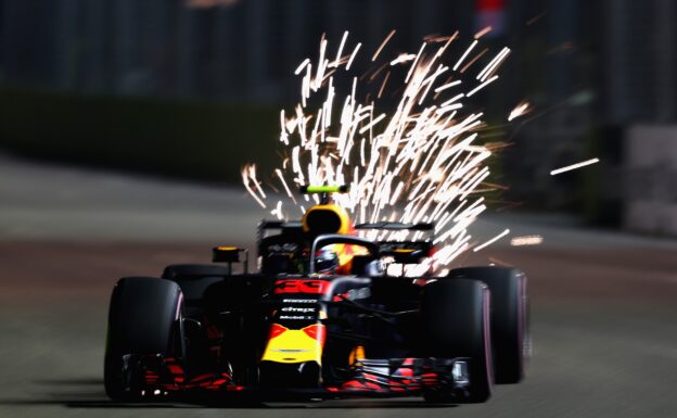 Sparks fly behind Max Verstappen driving the (33) Aston Martin Red Bull Racing RB14 TAG Heuer on track during qualifying for the Formula One Grand Prix of Singapore 2018.