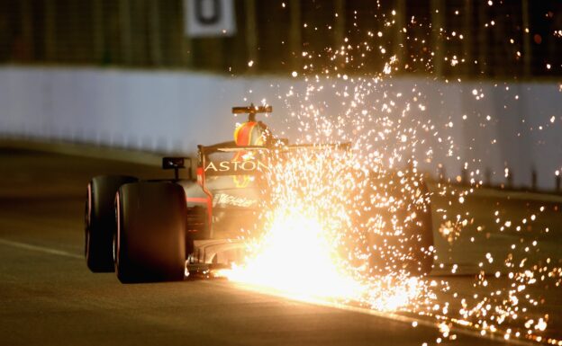 Sparks fly behind Daniel Ricciardo of Australia driving the (3) Aston Martin Red Bull Racing RB14 TAG Heuer on track during qualifying for the Formula One Grand Prix of Singapore 2018.