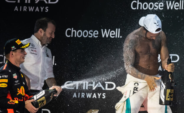 Race winner Lewis Hamilton of Great Britain and Mercedes GP and third placed Max Verstappen of Netherlands and Red Bull Racing celebrate on the podium during the Abu Dhabi Formula One Grand Prix at Yas Marina Circuit on November 25, 2018 in Abu Dhabi, United Arab Emirates.